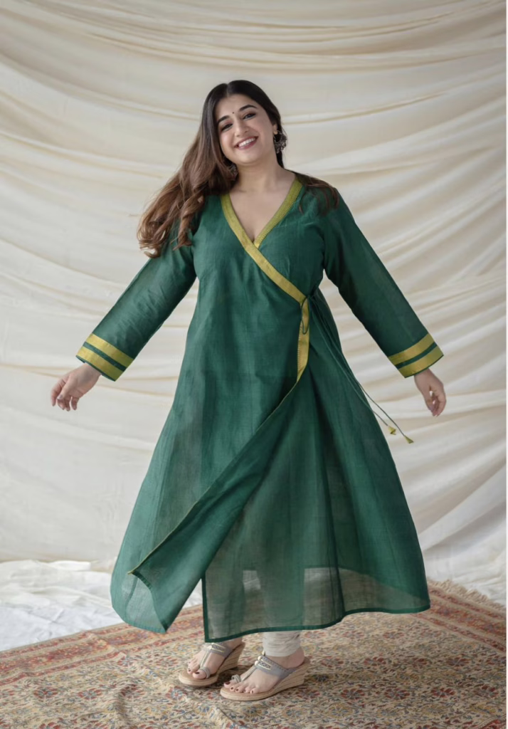 This is the image of a woman wearing a green Angrakha Kurti 