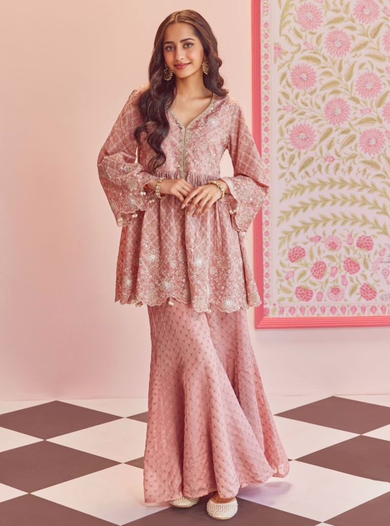 Top 5 Reasons Why Peplum Kurtis Deserve Space in Your Ethnic Wardrobe 8 Top 5 Reasons Why Peplum Kurtis Deserve Space in Your Ethnic Wardrobe This is the image of a woman wearing a pink peplum kurti