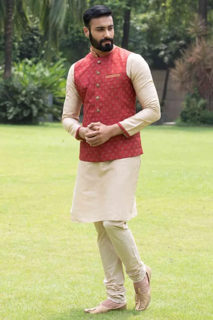 A man in a solid colored kurta , wearing a Modi Jacket