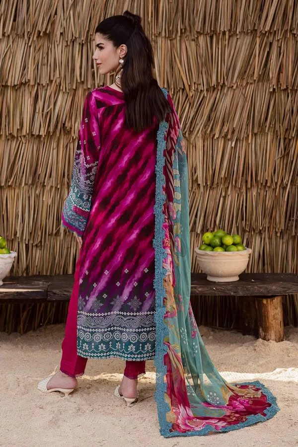 Woman wearing a vibrant magenta-printed ethnic suit with a teal floral-printed dupatta, posing outdoors against a rustic backdrop