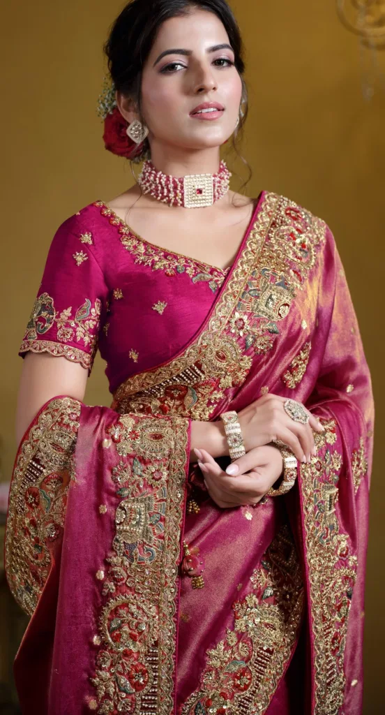 10 Wedding Saree Colors Decoded: What Works Best for Day and Evening Events 3 10 Wedding Saree Colors Decoded: What Works Best for Day and Evening Events Elegant magenta bridal saree with detailed gold embroidery, showcasing rich and vibrant wedding saree colors for a glamorous bridal look.