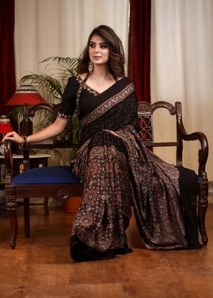 5 Super Simple Tips to Choose Your Saree Fall for the Perfect Drape 4 5 Super Simple Tips to Choose Your Saree Fall for the Perfect Drape A lady wearing a purple and lavender saree against a grey backdrop with a white flower vase