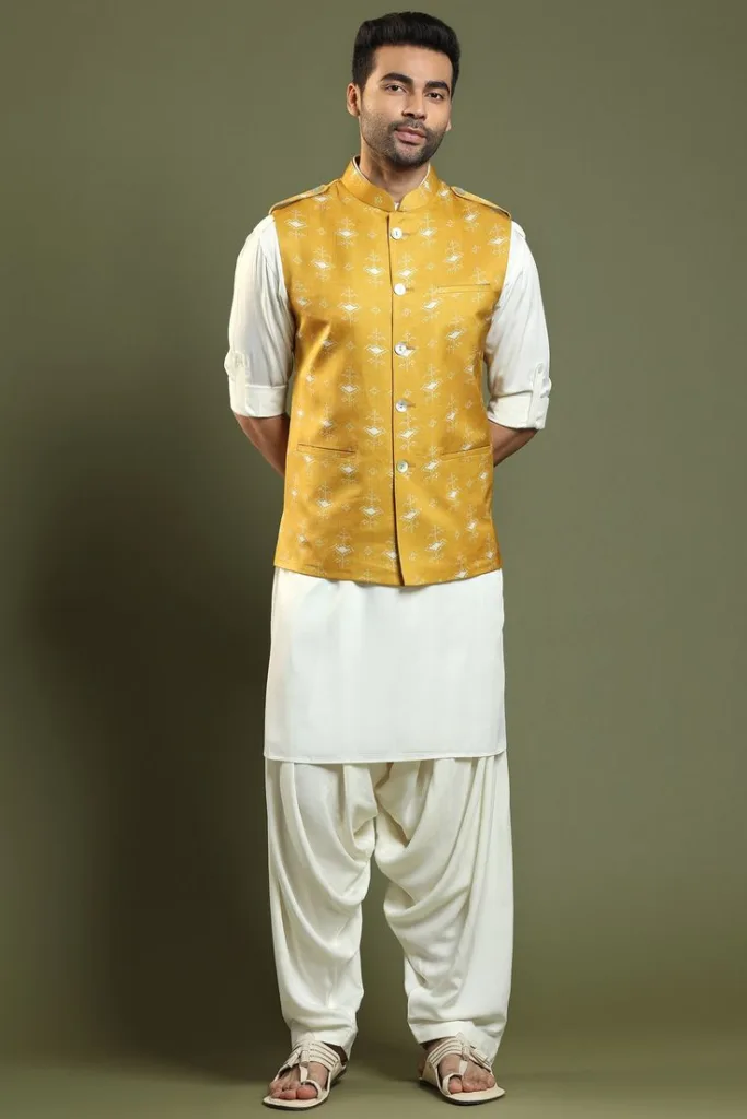 A man wearing kurta with dhoti pants and a jacket